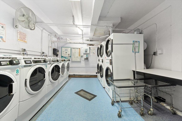 clothes washing area featuring stacked washing maching and dryer and washer and clothes dryer