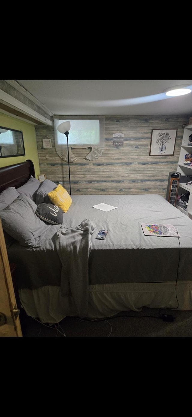 bedroom featuring wood walls