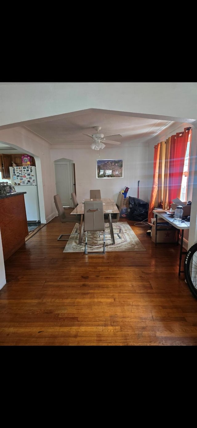 dining space with wood-type flooring and ceiling fan