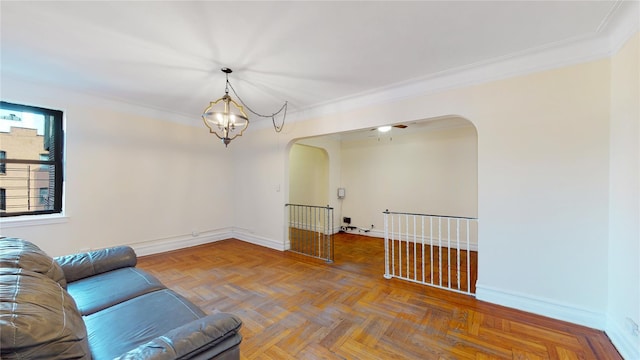 living room with a chandelier, parquet floors, and ornamental molding