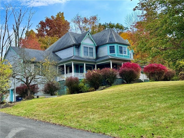 view of home's exterior with a lawn and covered porch