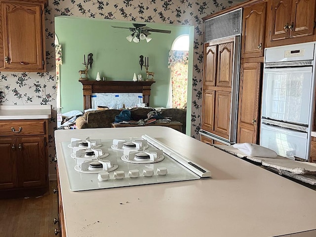 kitchen with white appliances, dark hardwood / wood-style floors, and ceiling fan