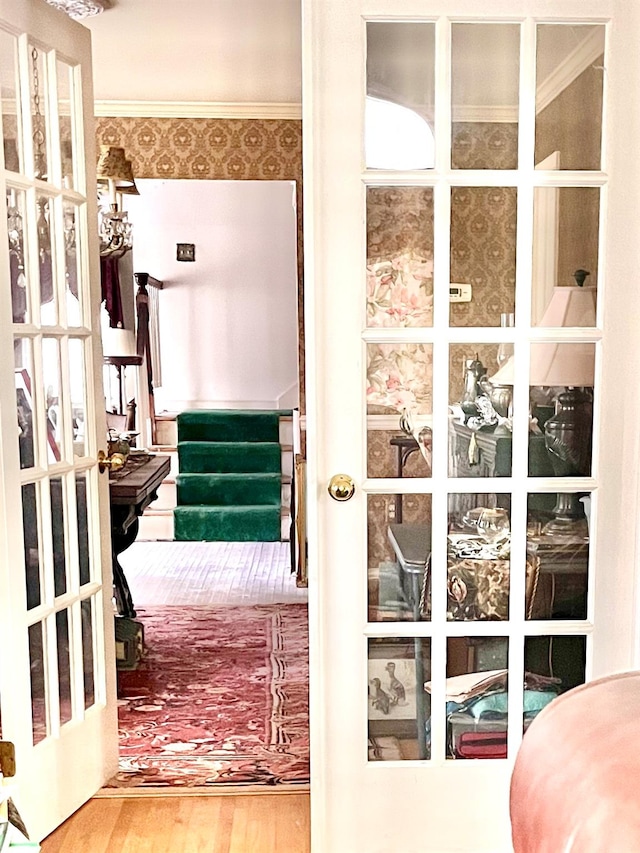 entryway featuring crown molding and wood-type flooring