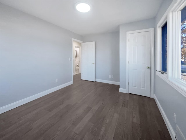 unfurnished bedroom featuring dark hardwood / wood-style floors