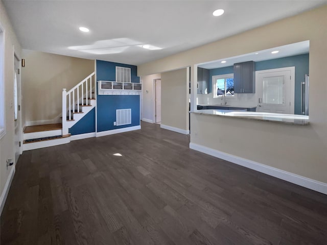 unfurnished living room featuring dark hardwood / wood-style flooring