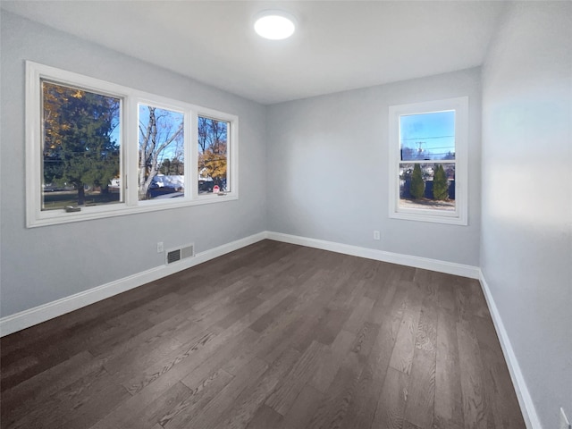 spare room with dark hardwood / wood-style flooring