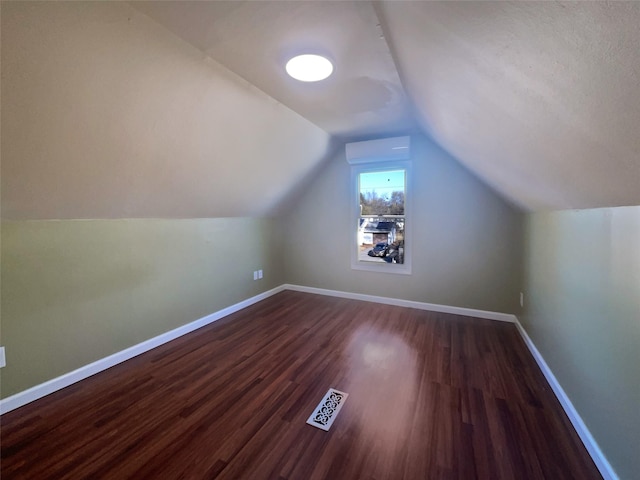 bonus room with vaulted ceiling and dark hardwood / wood-style floors