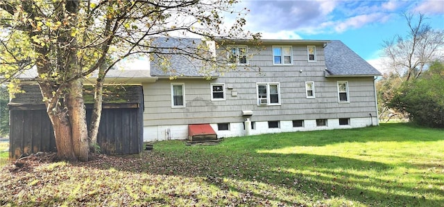 rear view of house with a yard