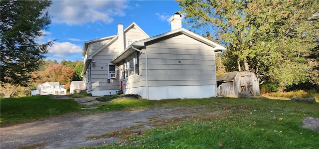 view of property exterior with a storage shed and a yard