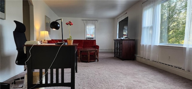 interior space with carpet flooring, plenty of natural light, and a baseboard heating unit