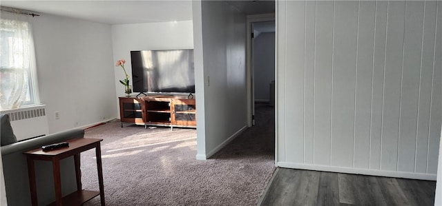 living room with radiator and dark wood-type flooring