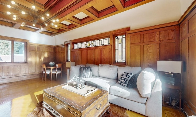 living room with dark hardwood / wood-style flooring, ornamental molding, coffered ceiling, wooden walls, and beam ceiling