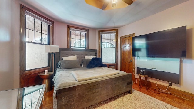 bedroom with ceiling fan and parquet floors