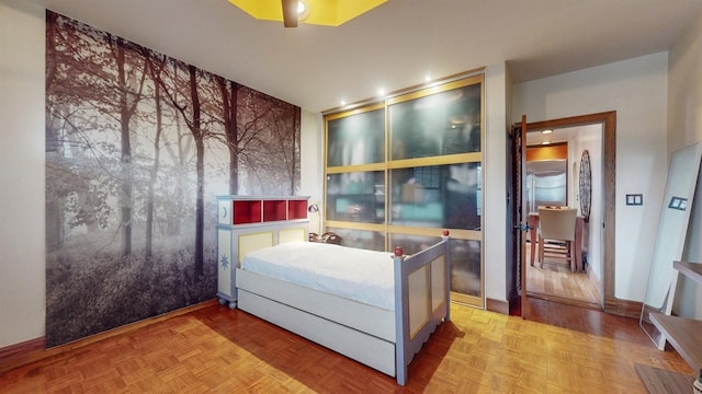 bedroom featuring light parquet flooring and ceiling fan