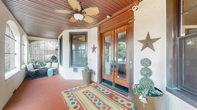 sunroom with ceiling fan, wood ceiling, and vaulted ceiling