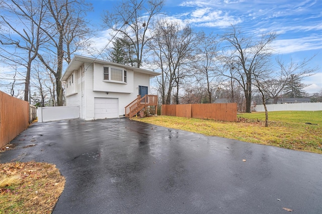 view of property exterior featuring a lawn and a garage