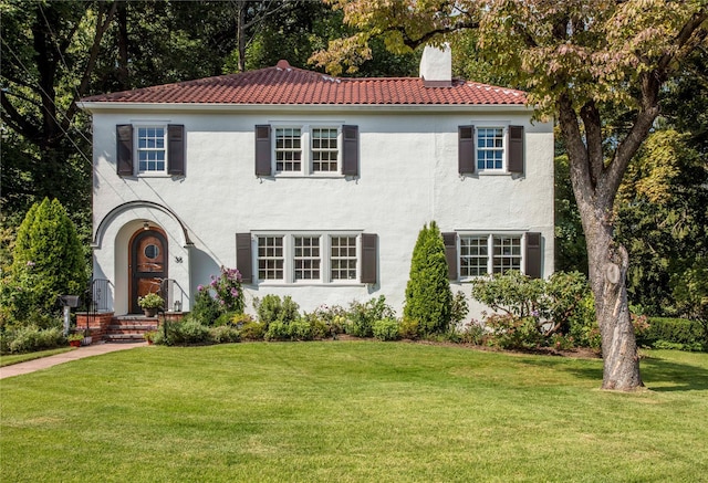 mediterranean / spanish-style home with a front lawn