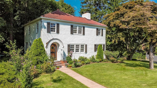 mediterranean / spanish-style home featuring a front lawn