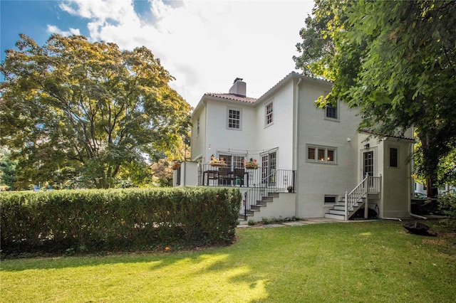 rear view of property with a lawn