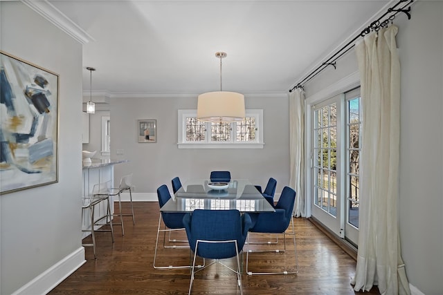 dining space with dark wood-type flooring and ornamental molding