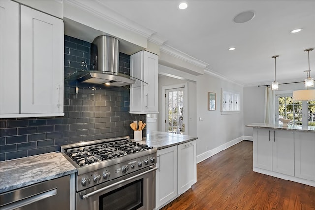 kitchen featuring white cabinets, stainless steel appliances, and wall chimney exhaust hood