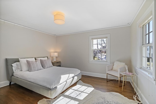 bedroom with dark hardwood / wood-style floors