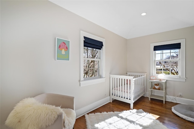 bedroom with dark hardwood / wood-style floors