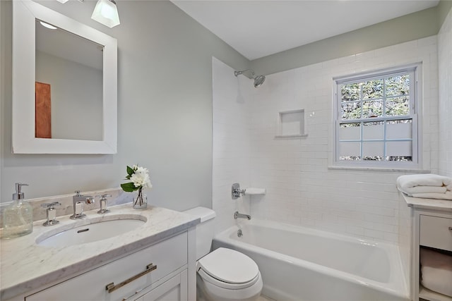 full bathroom with tiled shower / bath combo, vanity, and toilet