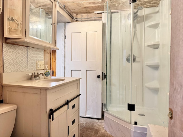 bathroom with vanity, an enclosed shower, and toilet