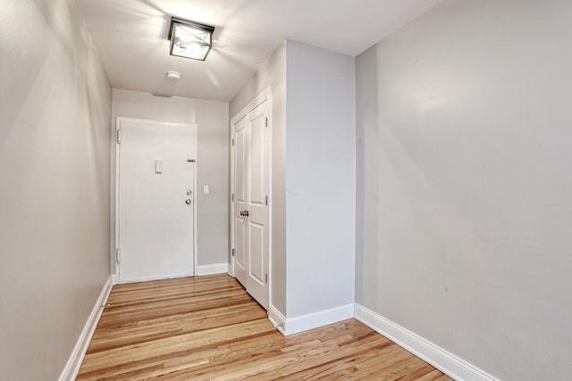 corridor with light hardwood / wood-style floors