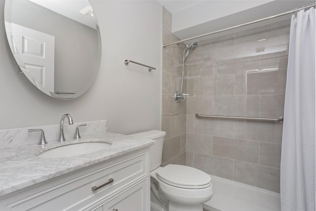 bathroom with curtained shower, vanity, and toilet