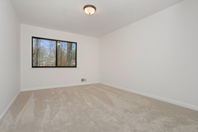 unfurnished room with light carpet