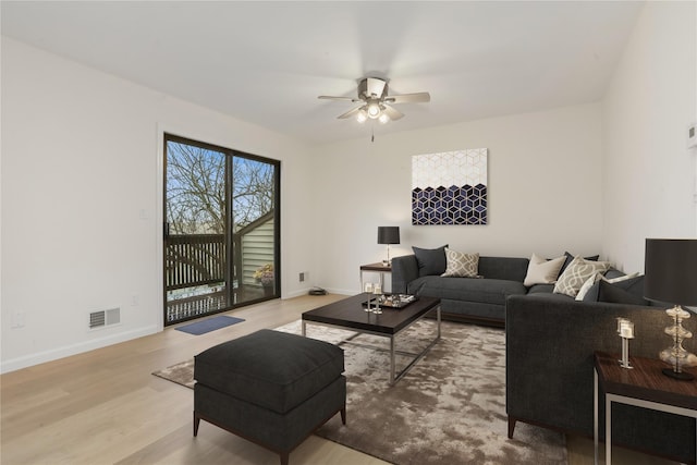 living room featuring ceiling fan and light wood-type flooring