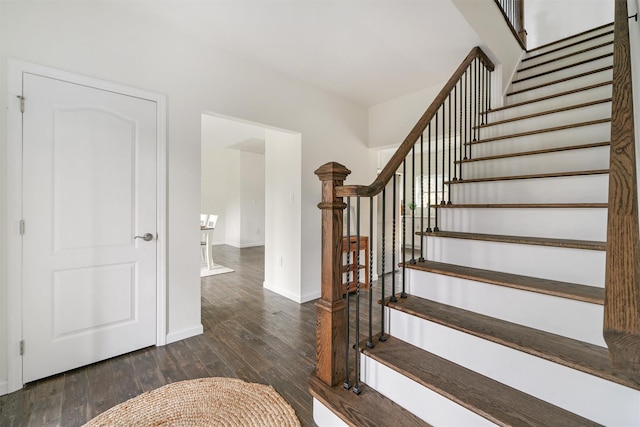 staircase featuring wood-type flooring