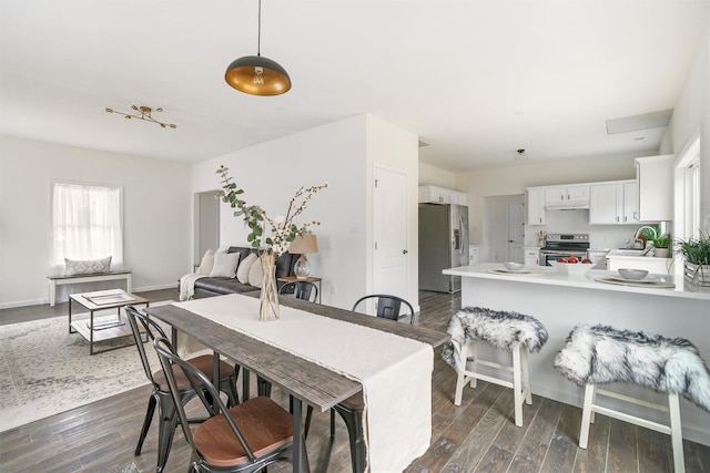 dining room with dark hardwood / wood-style flooring and sink