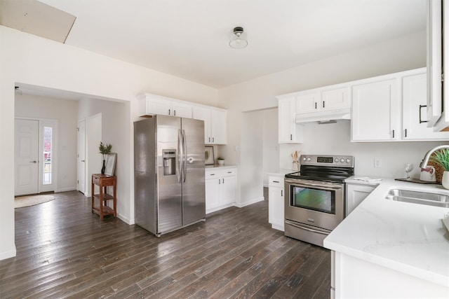 kitchen with appliances with stainless steel finishes, dark hardwood / wood-style flooring, light stone counters, sink, and white cabinetry