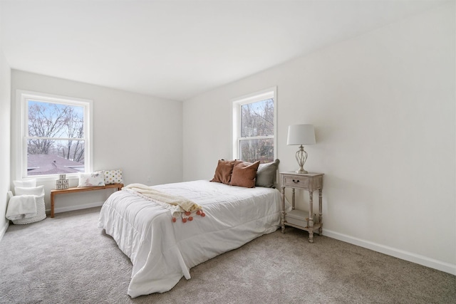 carpeted bedroom featuring multiple windows