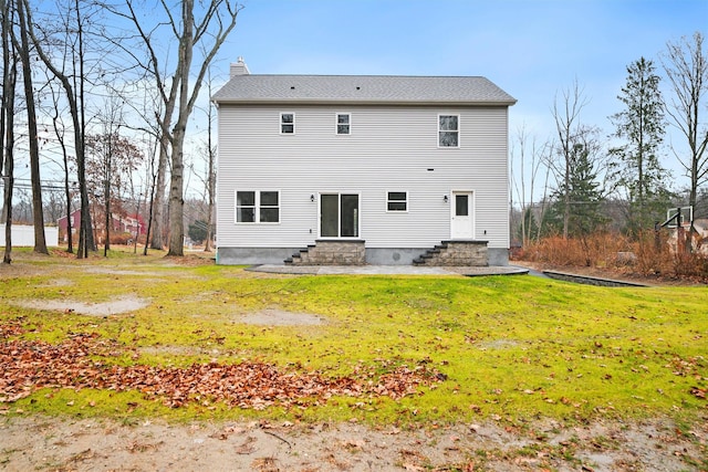 back of property featuring a lawn