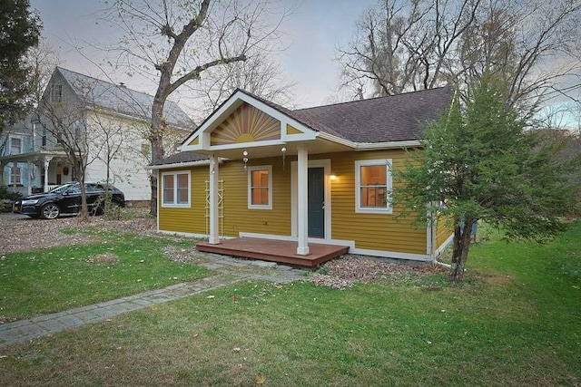 bungalow-style home with a porch and a front yard