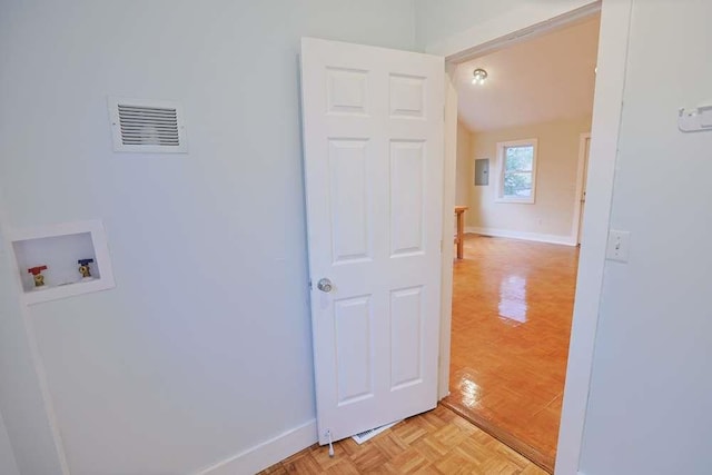 washroom with washer hookup and light parquet flooring