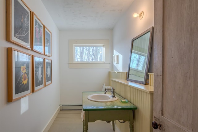 bathroom with vanity and a baseboard heating unit