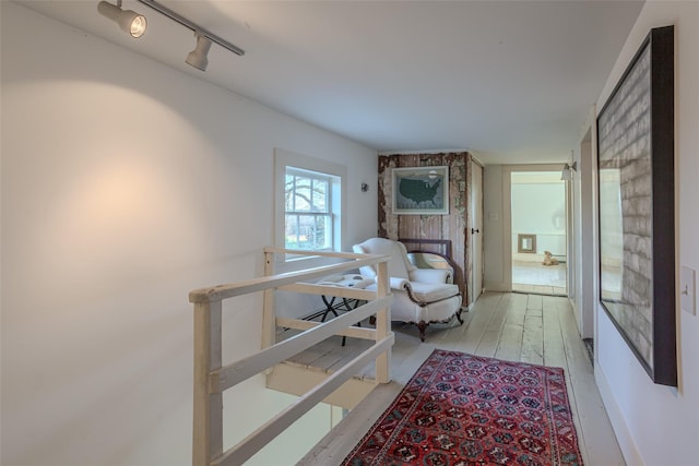 hallway featuring light hardwood / wood-style floors and track lighting