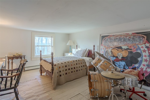 bedroom featuring light wood-type flooring and baseboard heating