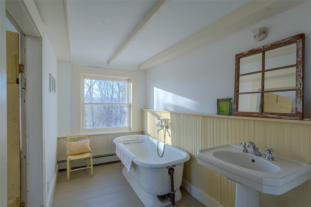 bathroom featuring hardwood / wood-style floors, sink, a bath, and a baseboard radiator