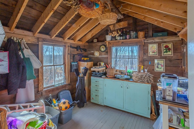 interior space featuring lofted ceiling with beams, light hardwood / wood-style floors, wooden ceiling, and wood walls