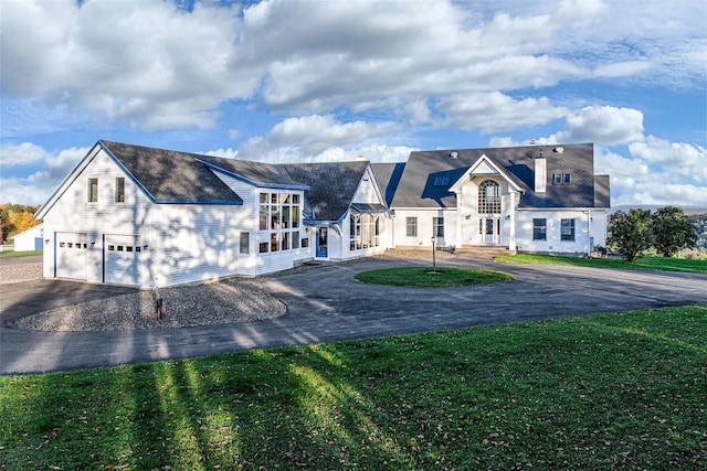 view of front of home with a garage and a front lawn