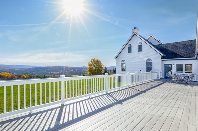 wooden deck featuring a yard