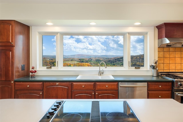 kitchen featuring a wealth of natural light, decorative backsplash, sink, and appliances with stainless steel finishes