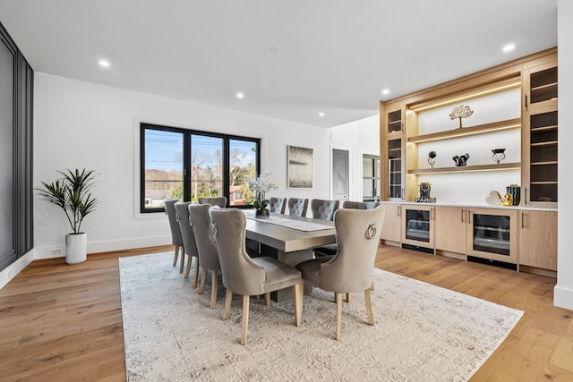 dining space featuring light hardwood / wood-style flooring and beverage cooler