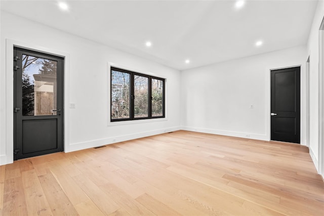 spare room with light hardwood / wood-style floors